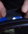 Hands installing Z-Liner Rim Tape Pair for 26, 27.5, and 29 Inch Wheels, 50mm Wide Purple Protective Barrier Between Inner Tube and Tire.