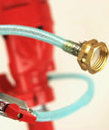 Close-up of blue braided hose with brass connector and red clamp on a red tool.