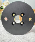 Rock Solid Self Centering CNC Vise Tailored For 4 And 5 Axis Milling showing the round black base with multiple holes for precision clamping.