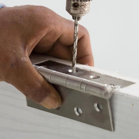 Hand drilling into a hinge on furniture, not the Heavy Duty 90 Degree Stainless Steel Corner Brackets Set Of Eight For Cabinets And Furniture L Shaped Triangular Braces That Add Stability And Durability Built To Last For DIY Projects And Home Improvement.