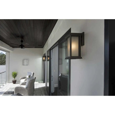 Endicott Collection 1-Light Outdoor Wall Lantern in Antique Bronze with Etched Umber Linen Glass on porch wall