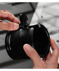 Close-up of 58mm Adjustable Portafilter Holder And Espresso Tamping Station equipped with heavy duty silicone mat in hand.