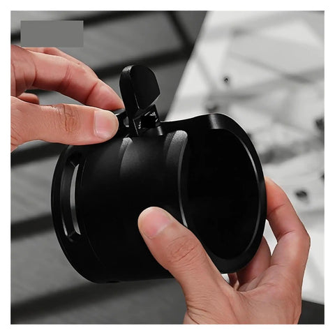Close-up of 58mm Adjustable Portafilter Holder And Espresso Tamping Station equipped with heavy duty silicone mat in hand.