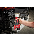 Milwaukee M12 Cordless Rivet Tool Bare Unit in hand, pulling a rivet, suitable for automotive repair with compact design.