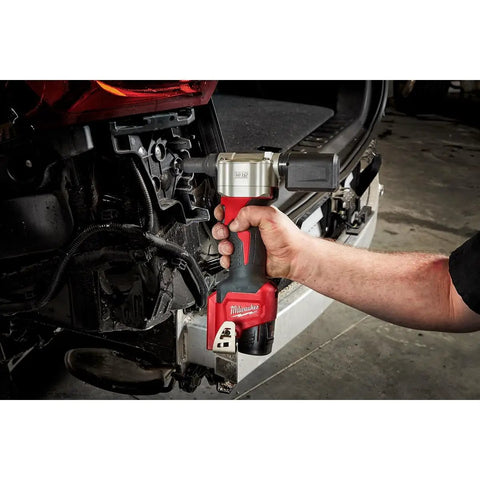 Milwaukee M12 Cordless Rivet Tool Bare Unit in hand, pulling a rivet, suitable for automotive repair with compact design.