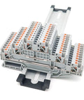 Three Level Push In Wire Terminals For Electrical Din Rail Setup No Sweat Snap Together Connectors For One Point Five Cables Built Like A Tank Pro Workspace Essentials Pack Of Ten mounted on DIN rail with multiple connectors.
