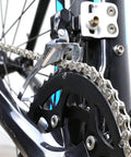 Close-up of 6/7/8 Speed Bike Chain One Half By Three Thirty Second Inch on a bike's drivetrain, showing 116 links with quick link.