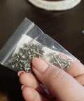 Kick Your Home Decor Up A Notch With These Legit Tough Vintage Silver Upholstery Nails 100 Piece Zinc Alloy Furniture Tacks in hand.