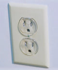 Super Stealthy Child Proof Outlet Covers 12 Pack Ultra Clear Plastic Electrical Safety Plugs Removable Reusable close-up of childproof outlet cover in white wall socket.