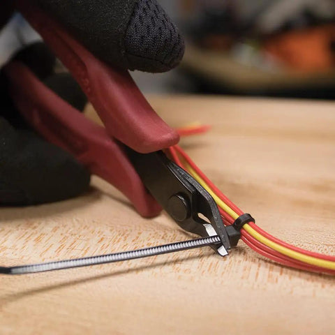 Ultra Slim 5-Inch Diagonal Flush Cutters snipping micro wire and zip ties in tight space, showing precise flat cut.