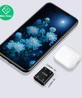 Dope 2 Channel Stereo Audio Mixer With Metal Shell And AUX, 2 In 1 Out Mini Sound Mixer next to smartphone and earbuds