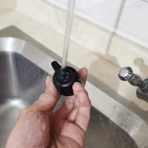 Person cleaning Steam Release Handle Valve For Foodi OP401 OP301 6.5 Qt And 8 Qt Series Replacement Pressure Cooker Part