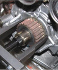 In-use view of RSYEKU two-jaw adjustable steel bearing puller removing a gear from a shaft (30–90 mm)