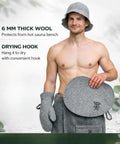 Man holding gray felt Wool Sauna Seat Cushion Pad For Benches Chairs Or Floors Comfy Handmade Gray Felt Heat Protector Insulated Mat