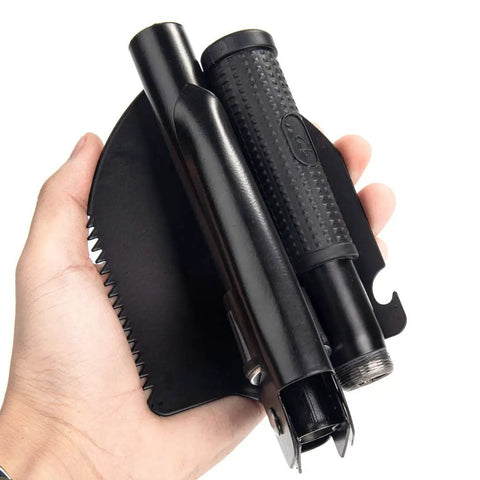 Hand holding Folding Survival Shovel For Camping And Trekking, All In One Entrenching Tool With Carry Pouch And Durable Metal Handle