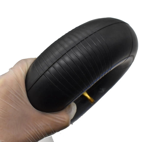 4 Pack Inner Tube For 4.10 3.50 4 Inch Tires With TR87 Bent Metal Valve Stem Heavy Duty held by gloved hand