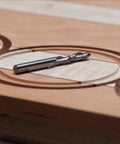 Close-up of wood with precise circle cuts using Pro Circle Cutting Router Jig, Polycarbonate Precision Tool For Woodworking.