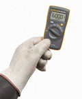 Person holding Compact Digital Multimeter With 0.5 Percent DC Accuracy, CAT III 600 V Safety, Diode And Continuity Test With Beeper