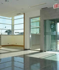 Single Sided LED Exit Sign With White Thermoplastic Housing, Switchable Red And Green Colors in an office entryway