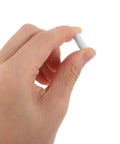 Hand holding a white spring loaded shutter repair pin from the Killer Quality 50 Pack Shutter Repair Pins for indoor blinds.