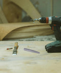 Top Tier Carbon Steel Bolt Extractor Set With Straight Flutes For Removing Stripped Screws And Broken Bolts Perfect For Garage Mechanics And Woodworking Projects That Need Tough Gear To Get The Job Done Right Fast. carbon steel extractor bit next to drill on wood bench