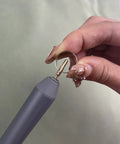 Grey foil quill pen starter kit with brass tip; close-up of tip held in hand.