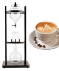 Straight Up Smooth High Borosilicate Glass Cold Brew Tower With Adjustable Drip Valve, 1250ml, on counter, alongside coffee cup.