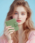 Woman holding a Slim Womens Bifold Wallet With 9 Card Slots, RFID Blocking, ID Window, and Compact Card Holder in Spearmint color