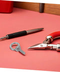 Stainless Steel Eyebolts With Closed Ring M6x20 For Heavy Duty Hanging, Beefy Load Bearing Eye Bolts With Washer And Nut, Concrete Or Wood Anchor Screws, Durable, Secure Mounts For Outdoor Gear Or Equipment close-up with pliers