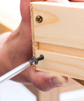 Installing Top Shelf Brass Decorative Screws With Caps For Cabinet Doors And Wood Furniture in a wooden project.