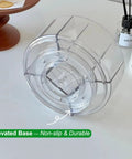 Base of 360 Degree Rotating Makeup Organizer With Lazy Susan Turntable, showing clear acrylic non-slip bottom on table.
