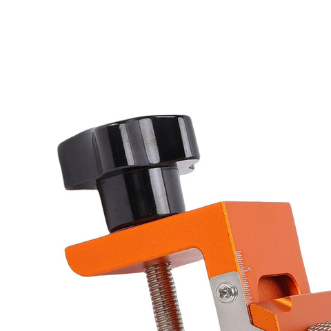 Close-up of Heavy Duty Double Hole Drill Guide With 12Mm Eccentric Nut, black knob on orange clamp for secure adjustments.