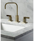 Antique Brass Widespread Bathroom Faucet With Drip Free Ceramic Disc Cartridge Deck Mount Eight To Sixteen Inch Three Hole Installation One Point Two GPM Flow At Sixty Psi One Half Inch IPS Connection Classic Modern Blend on marble countertop