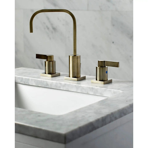 Antique Brass Widespread Bathroom Faucet With Drip Free Ceramic Disc Cartridge Deck Mount Eight To Sixteen Inch Three Hole Installation One Point Two GPM Flow At Sixty Psi One Half Inch IPS Connection Classic Modern Blend on marble countertop