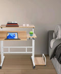 Effortless Folding Standing Desk With Smooth Rolling Casters And Tilted Writing Panels For Total Flex Work From Home Setup Featuring Quick Height Adjustments In Modern Light Walnut And White, with books and laptop.