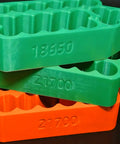 Ergonomic Battery Welding Jig For 18650 And 21700 Cells With Insulated Safety Clamps Quick Spotting Fixture stacked battery holders in green and orange
