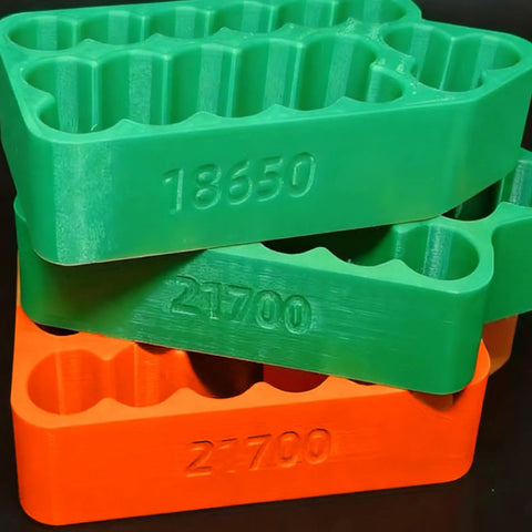 Ergonomic Battery Welding Jig For 18650 And 21700 Cells With Insulated Safety Clamps Quick Spotting Fixture stacked battery holders in green and orange