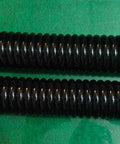 Built Tough Heavy Duty Extension Spring For Serious Torque Jobs And Garage Bay Ready Rigging Upgrades Crafted From Industrial High Strength Steel With Zero Fluff Tension Specs Twenty Inch Overall Length And Two Inch Outer Diameter, two black springs on a green surface.
