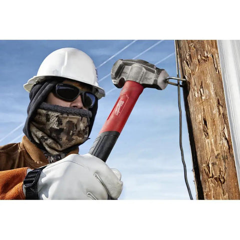 Absolute Beast Heavy Duty 4In1 Lineman Hammer 36 Oz Strike Built Different For Electricians And Job Site Pros Tough As Nails With Grippy Handle in use by a contractor on wooden pole.