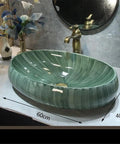 USZWBY Green Ceramic Oval Vessel Sink for Bathroom Balcony Outdoor Counter Top Vanity, 60cm x 40cm, elegant design on countertop.