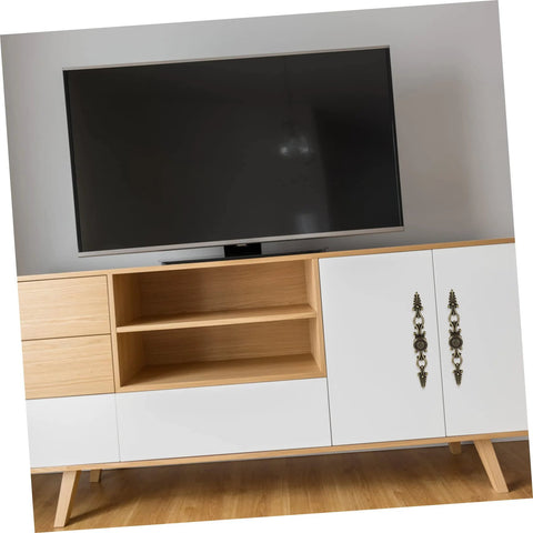 European Carving Handle 8.46 Inch Antique Bronze Cabinet Pulls installed on a white and wood cabinet under TV