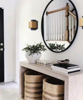 Indoor hallway with Gold And Black LED Outdoor Wall Light Fixture, modern wall mount next to a round mirror, warm white glow.