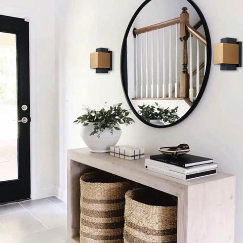 Indoor hallway with Gold And Black LED Outdoor Wall Light Fixture, modern wall mount next to a round mirror, warm white glow.