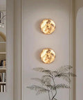ROPCVAX Wall Sconce Lamp Light Fixture Lighting Modern Nordic, circular Alabaster wall sconces glowing on a wall.