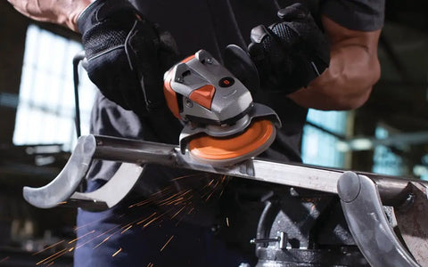 Person using Enduro-Flex 60 Grit Abrasive Flap Disc 5 Inch Pack Of Ten With Eco-Trim Backing on metal in workshop
