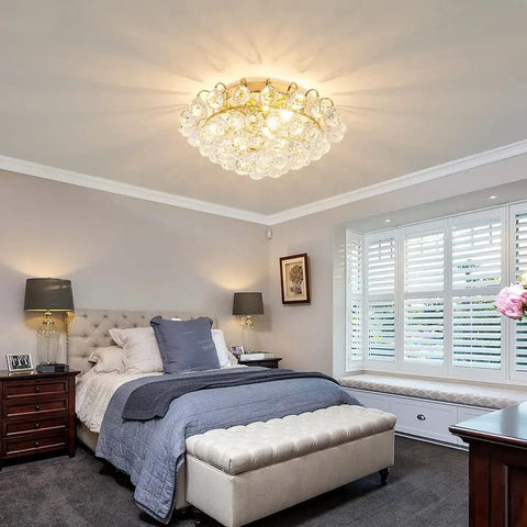 Three Light Modern Crystal Ceiling Light Fixture Flush Mount Round Golden Chandelier illuminating a bedroom with luxe vibe.