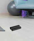 4 Pack Fitness Handle Grips For Barbells And Free Weights With Anti Slip Plastic Covers on gym floor