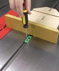 Bulletproof Zero Play Miter Stop Fence With Quick T Track Lock, adjusting with screwdriver on a table saw.