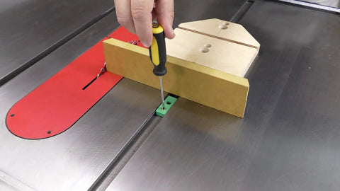 Bulletproof Zero Play Miter Stop Fence With Quick T Track Lock, adjusting with screwdriver on a table saw.