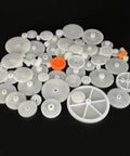 64Pcs 0.5 Module Plastic Gears Kit For DC Motors And DIY Robots includes spindle and crown gears, shown in a variety of sizes.